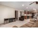 Cozy living room with a fireplace, seamless access to the kitchen, and neutral carpet at 8255 E Kiva Ave # 420, Mesa, AZ 85209