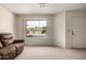 Cozy living room with neutral carpet, front door and a large window offering bright natural light at 8255 E Kiva Ave # 420, Mesa, AZ 85209