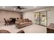 Inviting living and dining area with neutral carpet, slider door to covered patio, and ceiling fan at 8255 E Kiva Ave # 420, Mesa, AZ 85209