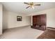 Spacious living room featuring neutral carpet, ample wall space, and a stylish built-in entertainment center at 8255 E Kiva Ave # 420, Mesa, AZ 85209