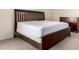 Well-lit main bedroom showcasing a dark wood bed frame and matching dresser at 8255 E Kiva Ave # 420, Mesa, AZ 85209