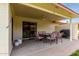 Serene covered patio with dining set, grill, and seamless indoor-outdoor flow through sliding glass doors at 8255 E Kiva Ave # 420, Mesa, AZ 85209