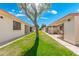 Backyard featuring a lush green lawn and pathways between buildings showcasing the community's landscape at 8255 E Kiva Ave # 422, Mesa, AZ 85209