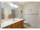 Bathroom featuring a vanity with sink, mirror, and a glass-enclosed shower at 8255 E Kiva Ave # 422, Mesa, AZ 85209