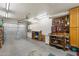 Spacious two-car garage with ample storage, a workbench, and functional organization space for tools at 8255 E Kiva Ave # 422, Mesa, AZ 85209