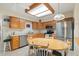 Bright kitchen with stainless steel appliances, wooden cabinetry, and an eat-in dining area at 8255 E Kiva Ave # 422, Mesa, AZ 85209