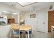 Open kitchen with a dining table, tile floors and connections to other living areas at 8255 E Kiva Ave # 422, Mesa, AZ 85209