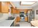 Well-lit kitchen featuring stainless steel appliances, light wood cabinets, and tile flooring at 8255 E Kiva Ave # 422, Mesa, AZ 85209
