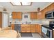 Functional kitchen with stainless steel appliances, classic wood cabinets, and tile flooring at 8255 E Kiva Ave # 422, Mesa, AZ 85209