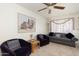 Comfortable living room featuring a ceiling fan, neutral carpet and a large painting at 8255 E Kiva Ave # 422, Mesa, AZ 85209