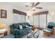 Cozy living room with a comfortable sofa, ceiling fan, and sliding glass doors leading to the outdoor space at 8255 E Kiva Ave # 422, Mesa, AZ 85209
