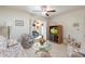Bright living room featuring a glass coffee table, ceiling fan, and entertainment center with TV at 8255 E Kiva Ave # 422, Mesa, AZ 85209