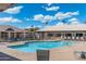 Community pool with lounge chairs for relaxing and enjoying the sun and lush landscaping at 8255 E Kiva Ave # 422, Mesa, AZ 85209
