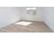 This is a bedroom with a window providing natural light and wood-look tile flooring at 852 W Golden Ore Pass, Apache Junction, AZ 85120