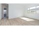 Bright bedroom features a window for natural light, light walls, and wood-look tile flooring at 852 W Golden Ore Pass, Apache Junction, AZ 85120