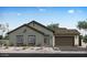 Charming single story home with a two car garage, low maintenance front yard and neutral colored exterior at 852 W Golden Ore Pass, Apache Junction, AZ 85120