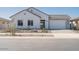 Charming single-story home featuring a two-car garage and professionally landscaped front yard at 852 W Golden Ore Pass, Apache Junction, AZ 85120