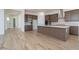 Modern kitchen with stainless steel appliances, center island, and wood-style tile flooring at 852 W Golden Ore Pass, Apache Junction, AZ 85120