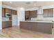 Modern kitchen with stainless steel appliances, center island, and wood-style tile flooring at 852 W Golden Ore Pass, Apache Junction, AZ 85120