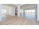 Bright open living room featuring wood-look tile flooring and access to the kitchen at 852 W Golden Ore Pass, Apache Junction, AZ 85120