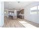 Open-concept living area and kitchen with recessed lighting and wood-style tile flooring at 852 W Golden Ore Pass, Apache Junction, AZ 85120