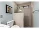 Bathroom showing tiled shower with glass enclosure and mosaic tile floor at 9243 W Kimberly Way, Peoria, AZ 85382