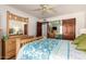 This home features a bedroom with a ceiling fan and wood furniture at 9243 W Kimberly Way, Peoria, AZ 85382