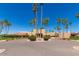 The Lakes clubhouse with desert landscaping, circular drive, and palm trees creates an inviting entrance at 9243 W Kimberly Way, Peoria, AZ 85382