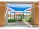 Community pool featuring colorful sun shades and well-maintained landscaping at 9243 W Kimberly Way, Peoria, AZ 85382