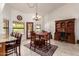 Sunny dining area with tile floors, a dark wood hutch, and a chandelier at 9243 W Kimberly Way, Peoria, AZ 85382