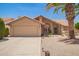Charming single-story home with a two-car garage, desert landscaping, and tile roof at 9243 W Kimberly Way, Peoria, AZ 85382
