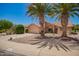Desert home featuring mature landscaping, a two-car garage, and a beautiful red tile roof at 9243 W Kimberly Way, Peoria, AZ 85382