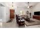 Bright living room featuring tile floors, tan couches, and a stained-glass window at 9243 W Kimberly Way, Peoria, AZ 85382