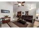 Spacious living room with tile floors, couches, and dark wood furniture at 9243 W Kimberly Way, Peoria, AZ 85382