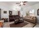 Open-concept living room features tile floors, tan couches, and a large window at 9243 W Kimberly Way, Peoria, AZ 85382