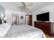 Bright bedroom with a tv, ensuite bathroom, and walk-in closet at 9243 W Kimberly Way, Peoria, AZ 85382