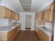 Open kitchen features light wood cabinets, ample counter space, and modern appliances at 9426 N 109 Th Dr, Sun City, AZ 85351