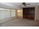 Living room featuring built-in bookshelves, large windows, and carpeted floors at 9426 N 109 Th Dr, Sun City, AZ 85351