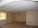 Living room with carpeted floors, a chandelier, and natural light from a window at 9426 N 109 Th Dr, Sun City, AZ 85351