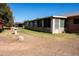 Backyard featuring sunroom addition, complimented by trees, grass, and a spacious yard at 9602 W Ironwood Dr # A, Peoria, AZ 85345