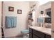 Cozy bathroom with light blue accent towels, a single sink vanity and decorative wall art at 9602 W Ironwood Dr # A, Peoria, AZ 85345