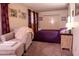 Bedroom with cozy chair, complemented by a large closet, and side table with bedside lamp at 9602 W Ironwood Dr # A, Peoria, AZ 85345
