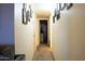 Hallway with carpet flooring and neutral walls adorned with framed pictures and artwork at 9602 W Ironwood Dr # A, Peoria, AZ 85345
