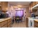 Well-lit kitchen and dining area features light-colored cabinets and a cozy atmosphere at 9602 W Ironwood Dr # A, Peoria, AZ 85345