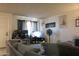 Open living room featuring a spacious gray sectional, TV setup and comfortable décor at 9602 W Ironwood Dr # A, Peoria, AZ 85345