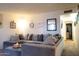 Bright living room showcasing a gray sectional sofa, providing ample seating and comfort at 9602 W Ironwood Dr # A, Peoria, AZ 85345