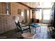 Bright sunroom featuring a cozy rocking chair, brick walls, and a sliding door to the outdoors at 9602 W Ironwood Dr # A, Peoria, AZ 85345