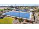 An aerial view showcases the community recreational amenities including a pool, pickleball and basketball courts at 9964 W Piccadilly Rd, Avondale, AZ 85392