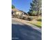 Charming home exterior featuring lush landscaping, mature trees, and well-maintained lawn and shrubbery at , Mesa, AZ 85205