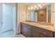 Updated bathroom with a double sink vanity, granite countertops, and a shower with a tile surround at 100 E Fillmore St # 227, Phoenix, AZ 85004